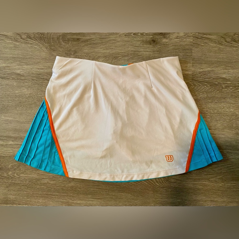 White and blue tennis skirt with orange details